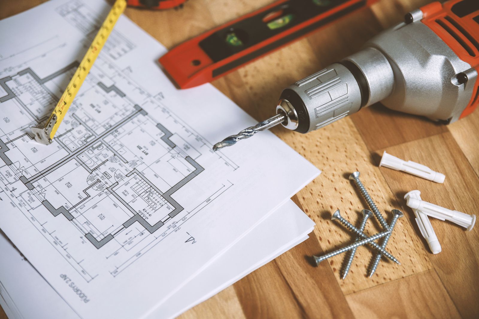 Floor plan and drafting tools on a work table
