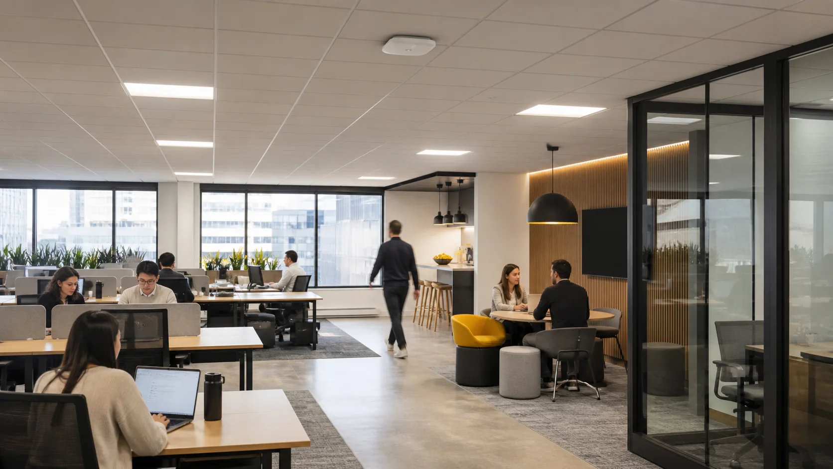 People using a shared commercial office beneath a ceiling-mounted wireless access point