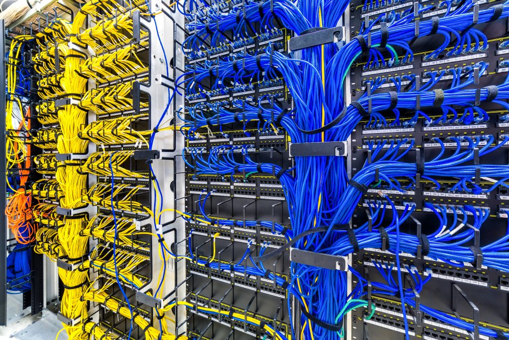Rack with generic ethernet cat5e cables, part of a large company data center.